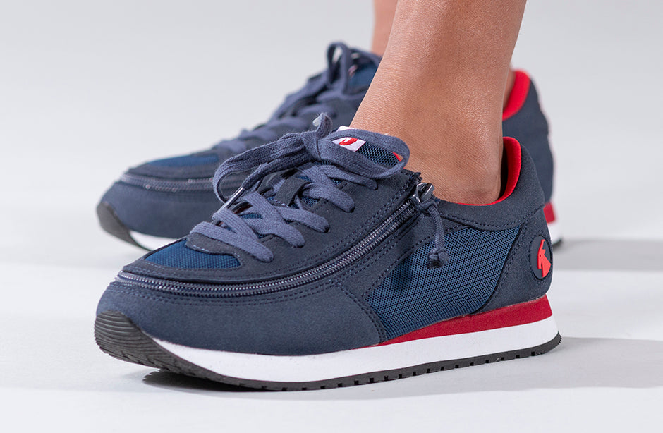 Kid's Navy/Red BILLY Joggers, zipper shoes, like velcro, that are adaptive, accessible, inclusive and use universal design to accommodate an afo. Footwear is medium and wide width, M, D and EEE, are comfortable, and come in toddler, kids, mens, and womens sizing.